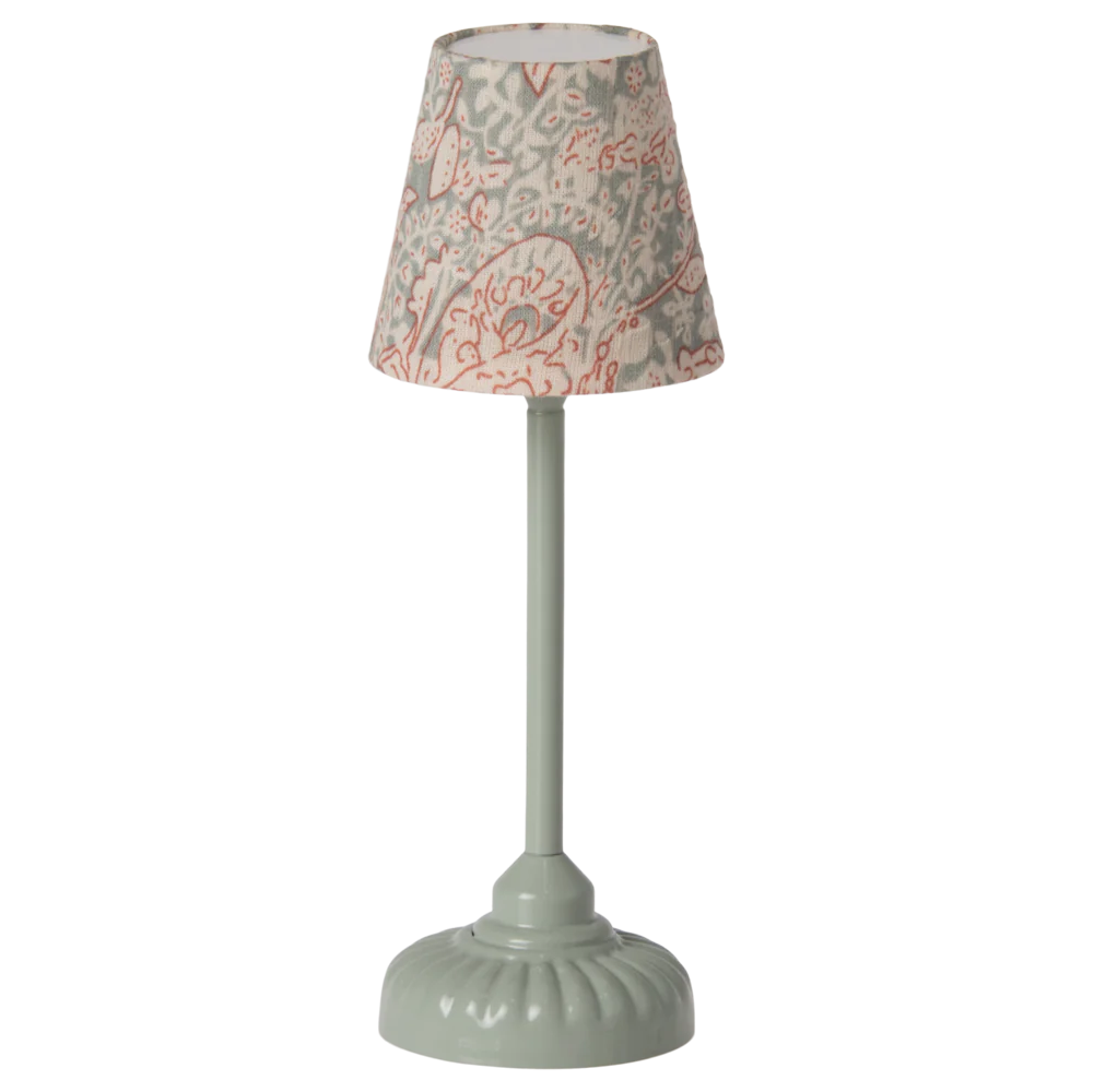 A mint-colored Maileg vintage floor lamp with a patterned shade and a solid green base.
