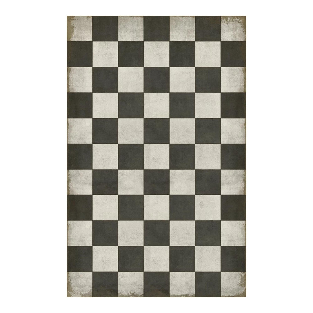 Checkered rug with black and white squares on a plain background