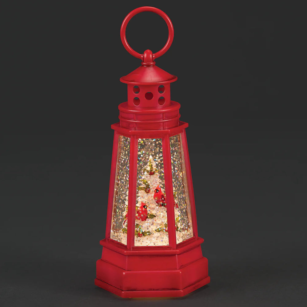 Red lantern with a Christmas scene inside on a black background