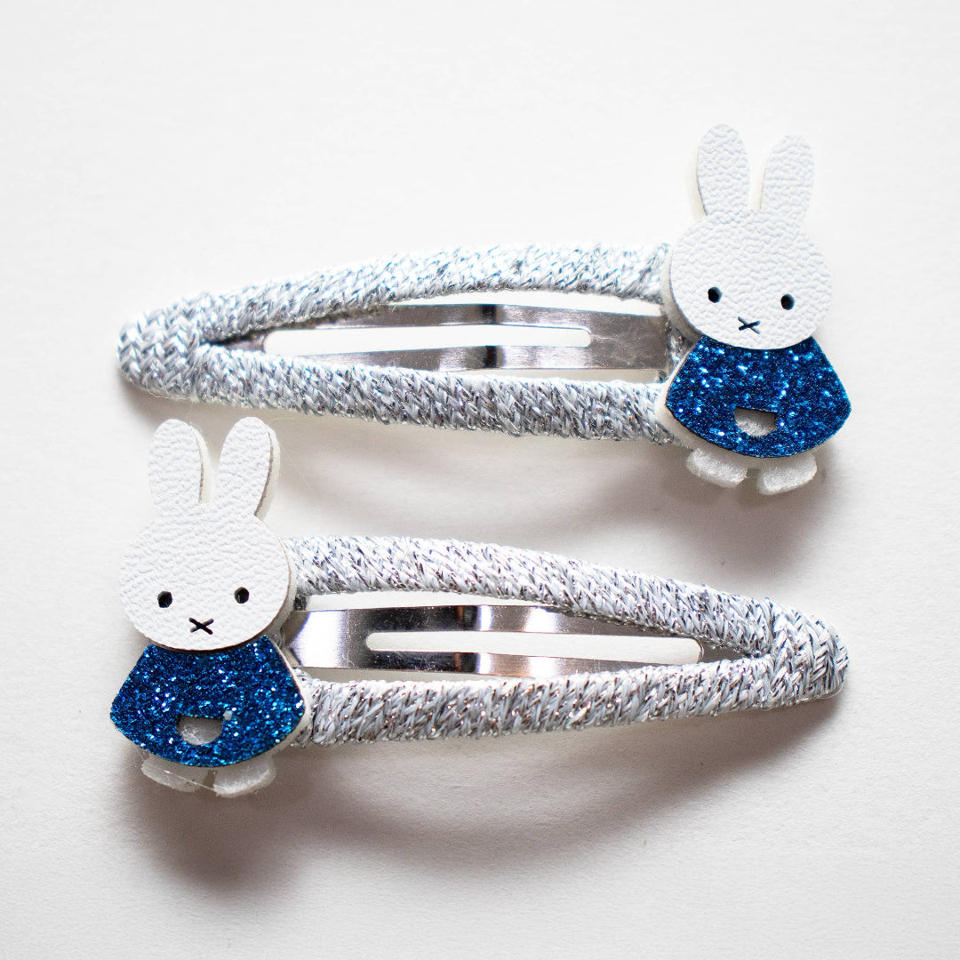 Two barettes featuring a cute Miffy bunny wearing a blue glitter dress.