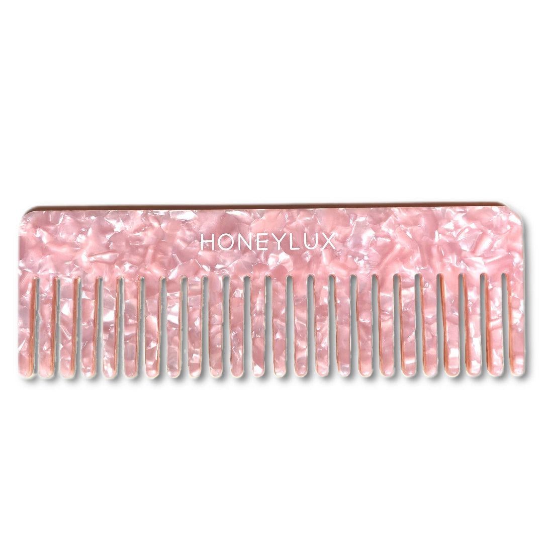 Pink marbled comb with 'Honeylux' branding on a white background
