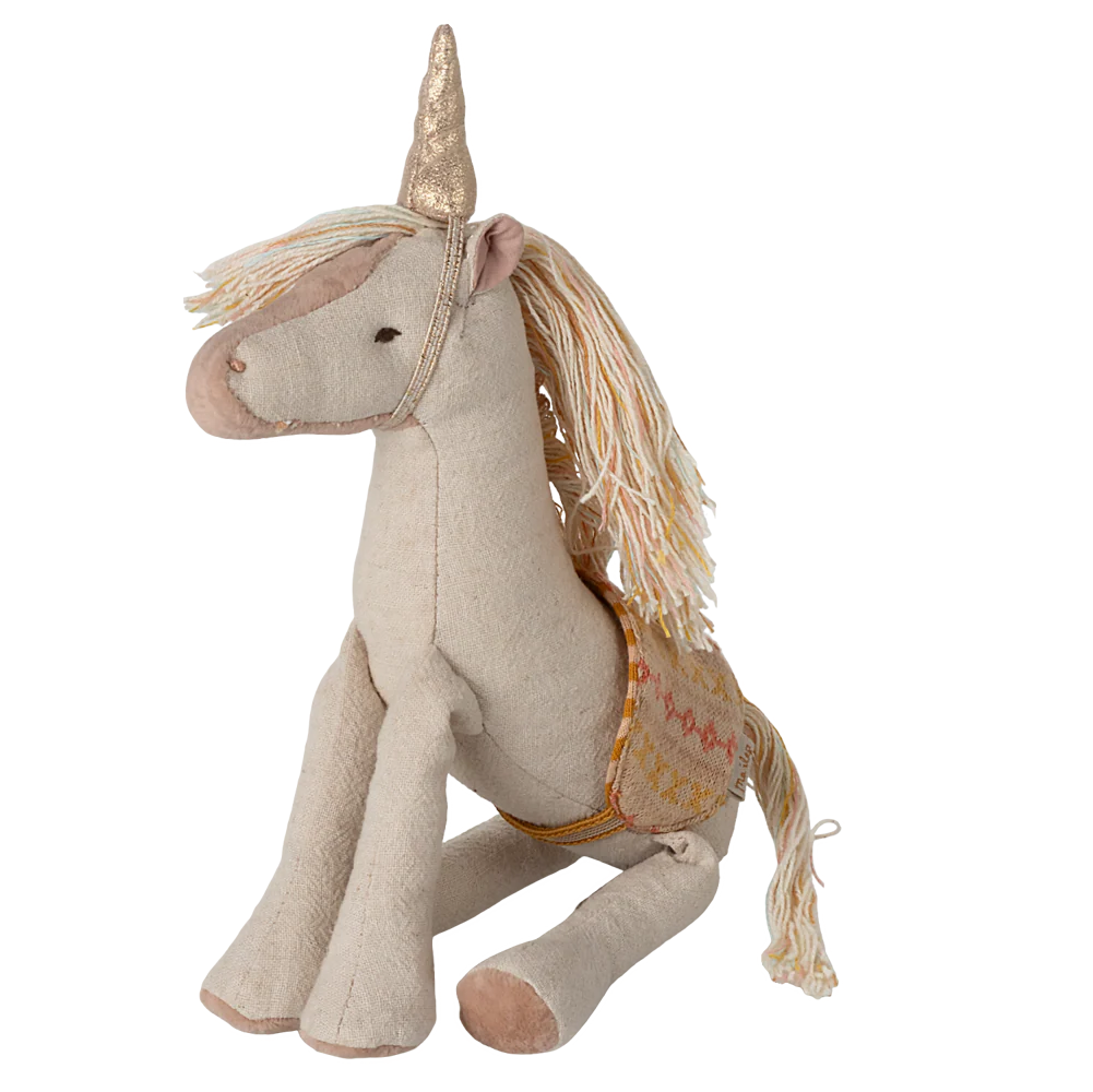 Stuffed unicorn toy with a gold horn and mane on a white background