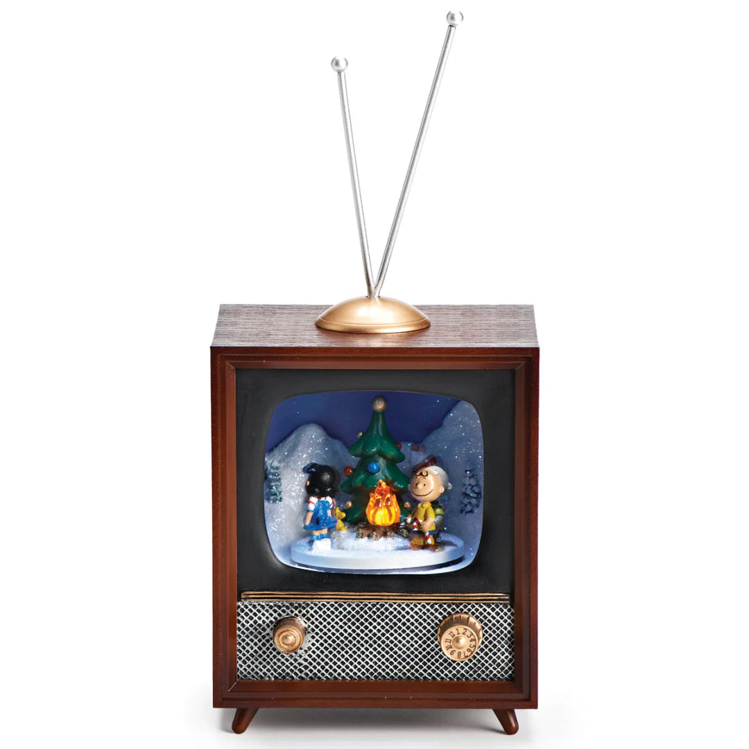 Vintage-style television with a snow globe display featuring characters around a Christmas tree.