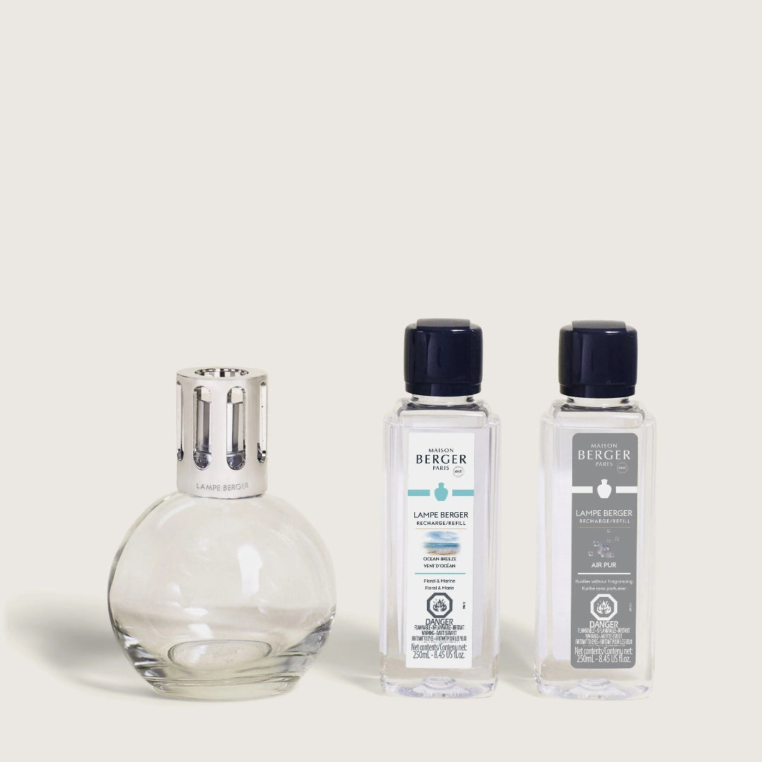 A Maison Berger fragrance lamp with a metal top alongside two 250ml refills labeled 'Ocean Breeze' and 'Air Pur So Neutral'.
