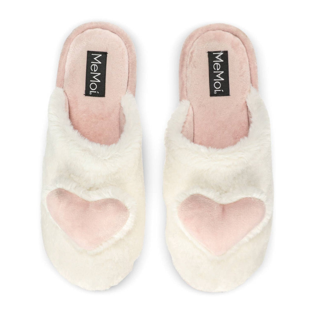Pair of white fuzzy slippers with pink hearts and 'Memo' label on a white background