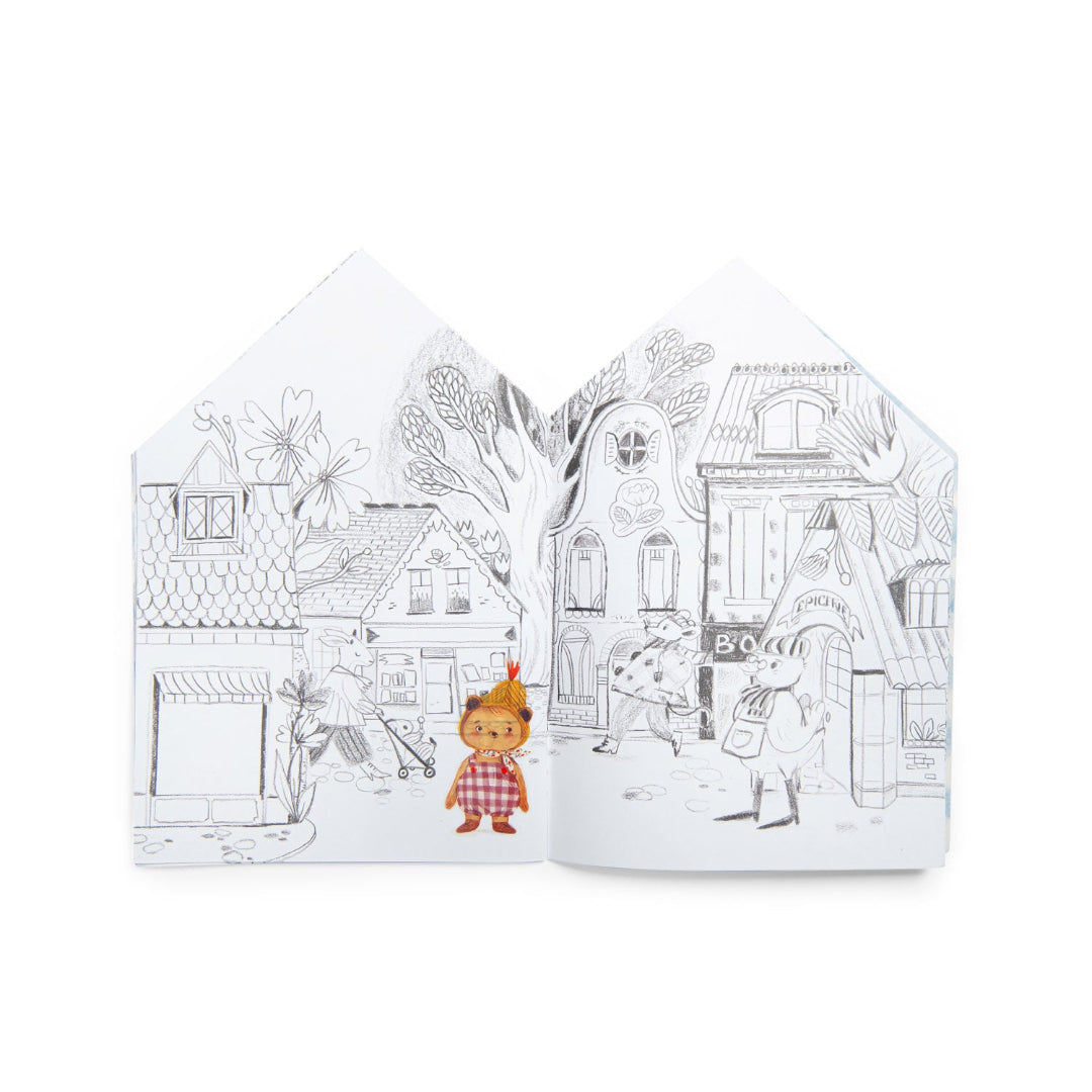 Two coloring books with illustrations of a village scene on a white background