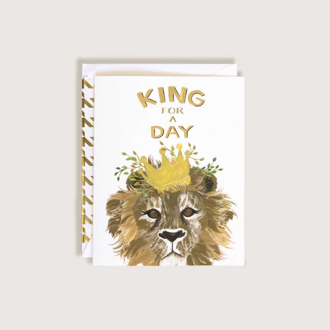 Greeting card with a lion wearing a crown and 'King for a Day' text on a white background.