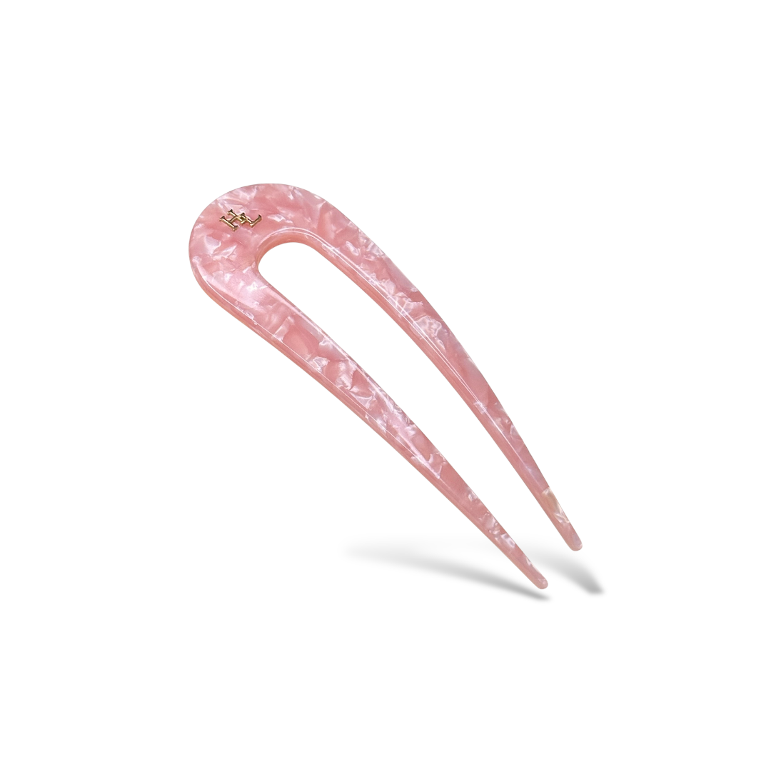 Pink hair pick with marbled design on a white background