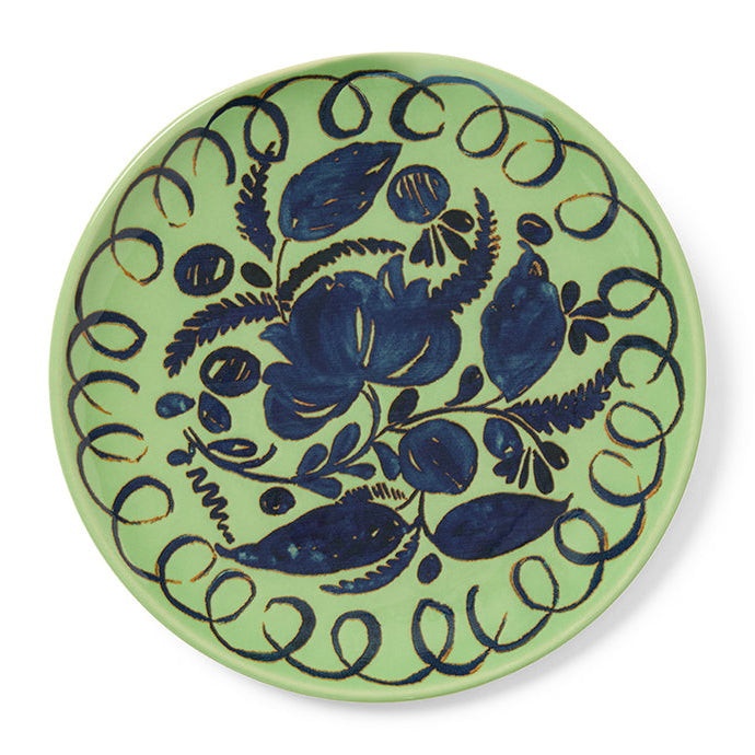 Greebn decorative plate with blue floral design on a white background