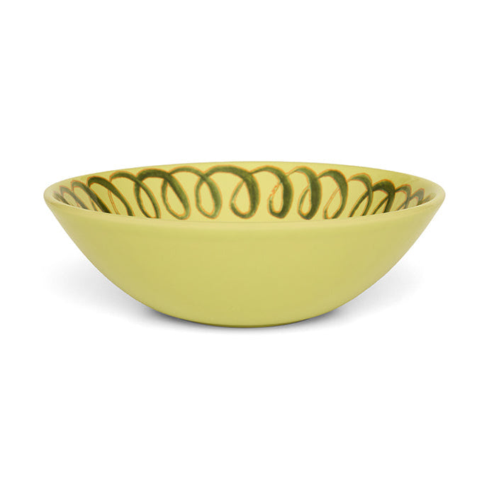 Green ceramic bowl with decorative rim on a white background
