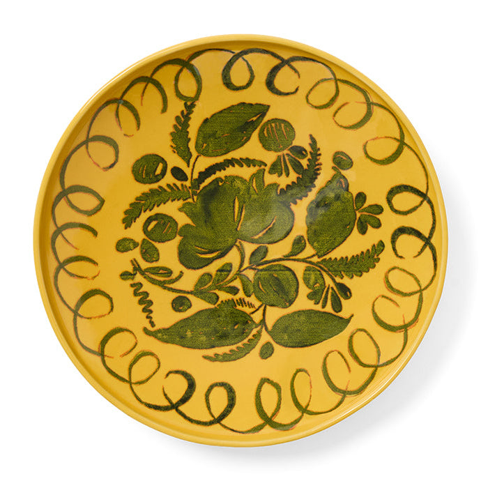 Yellow plate with green floral design on a white background