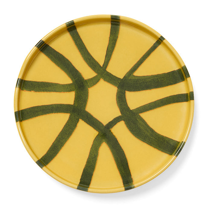 Yellow plate with green abstract patterns on a white background