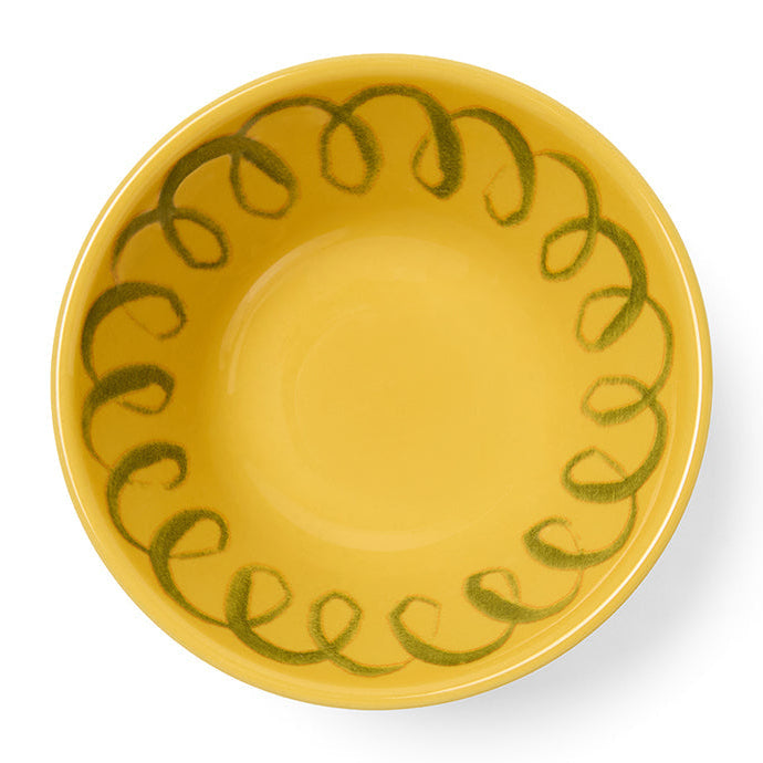 Yellow ceramic plate with green decorative pattern on a white background