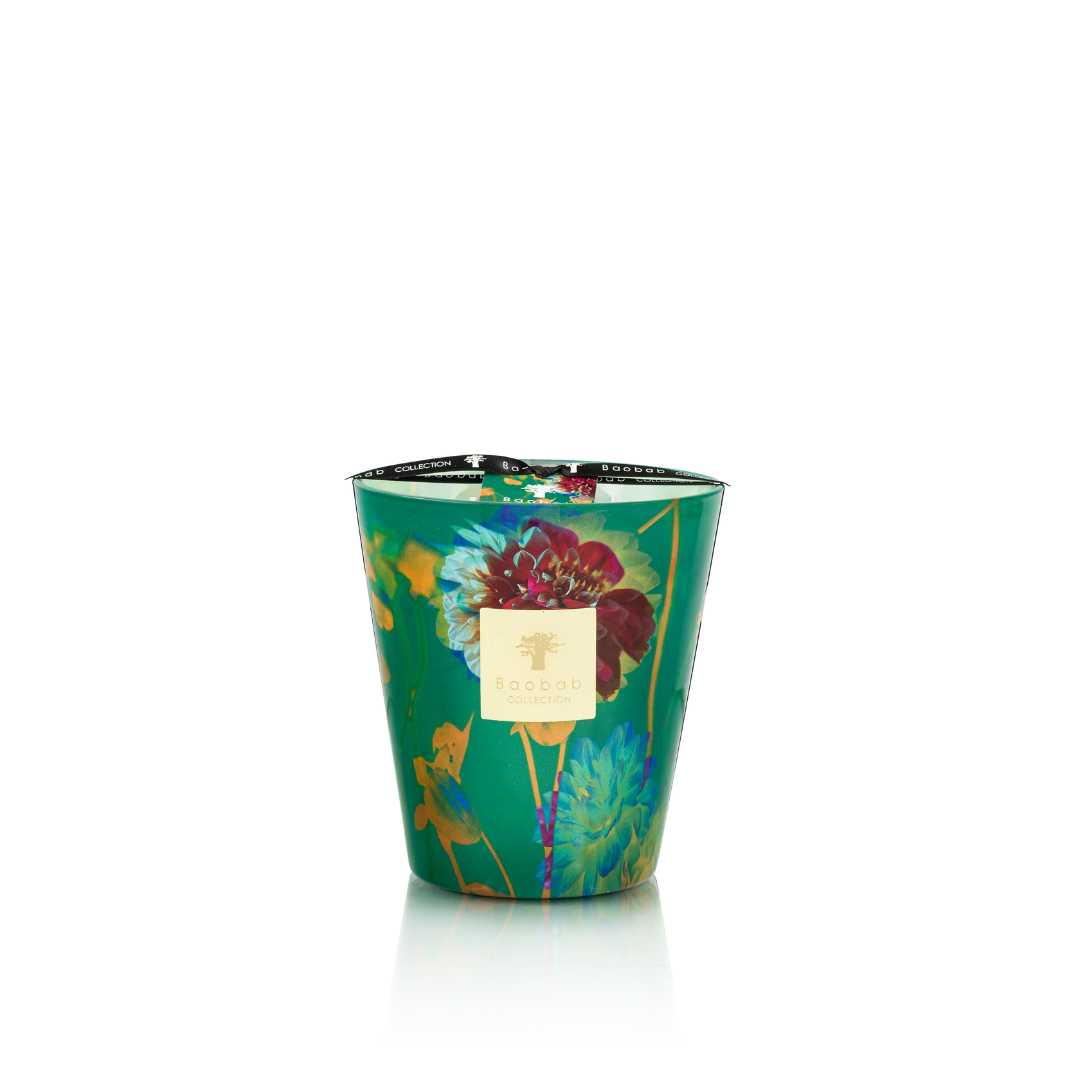Decorative candle in a green container with floral design on a white background