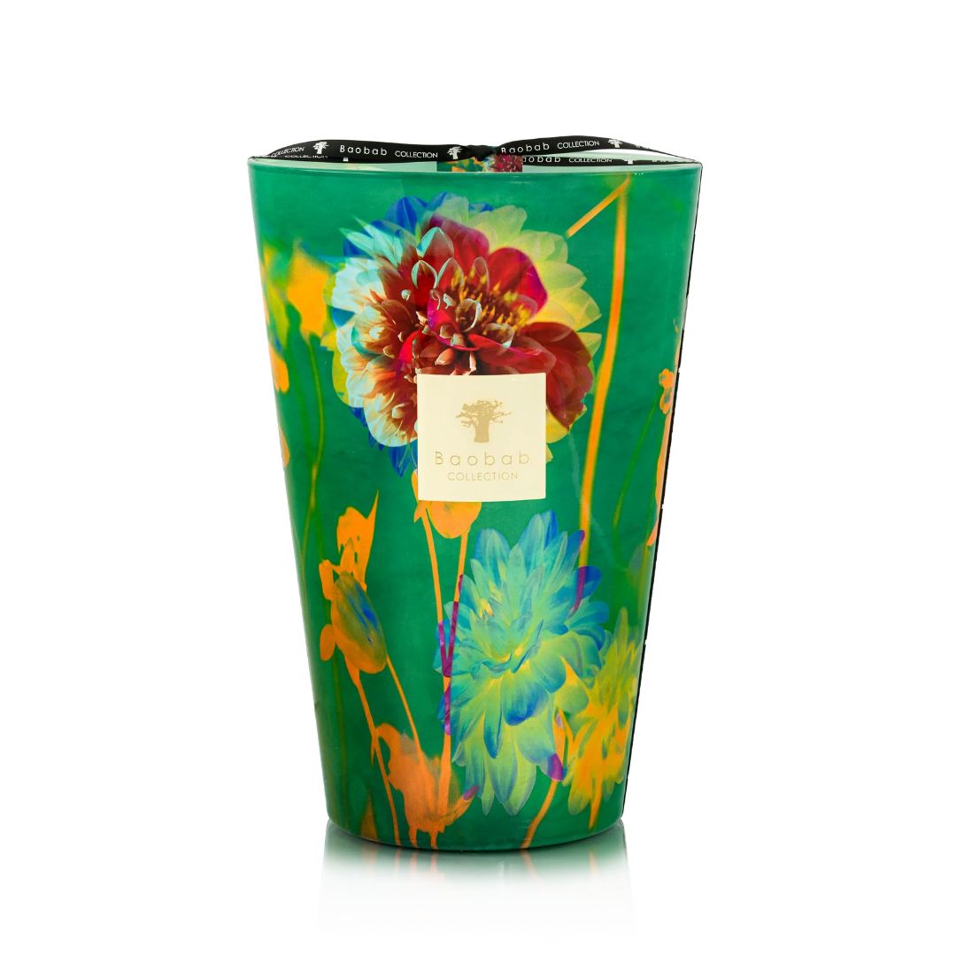 Colorful floral-patterned candle in a green container on a white background