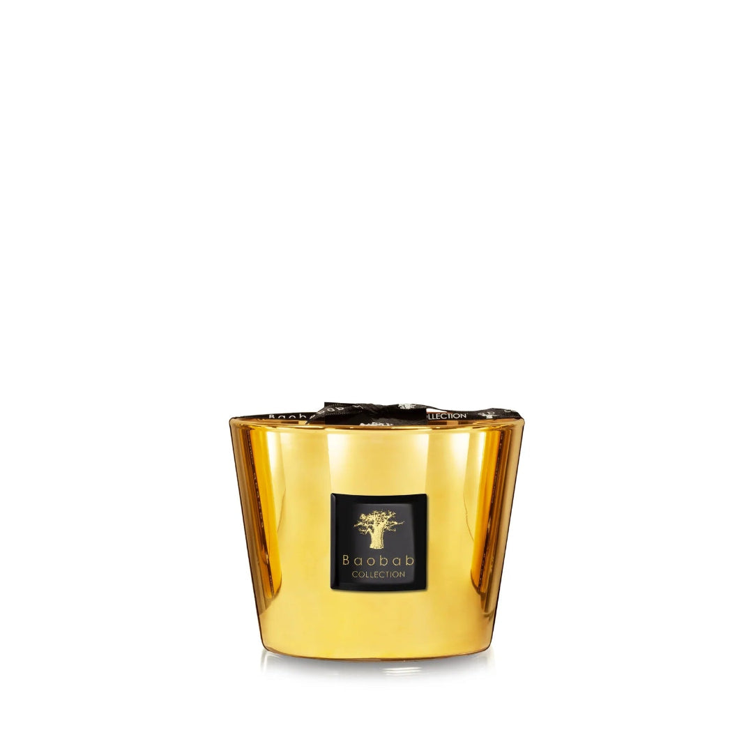 A collection of gold colored candles with glass containers, each with a label reading 'Baobab'.