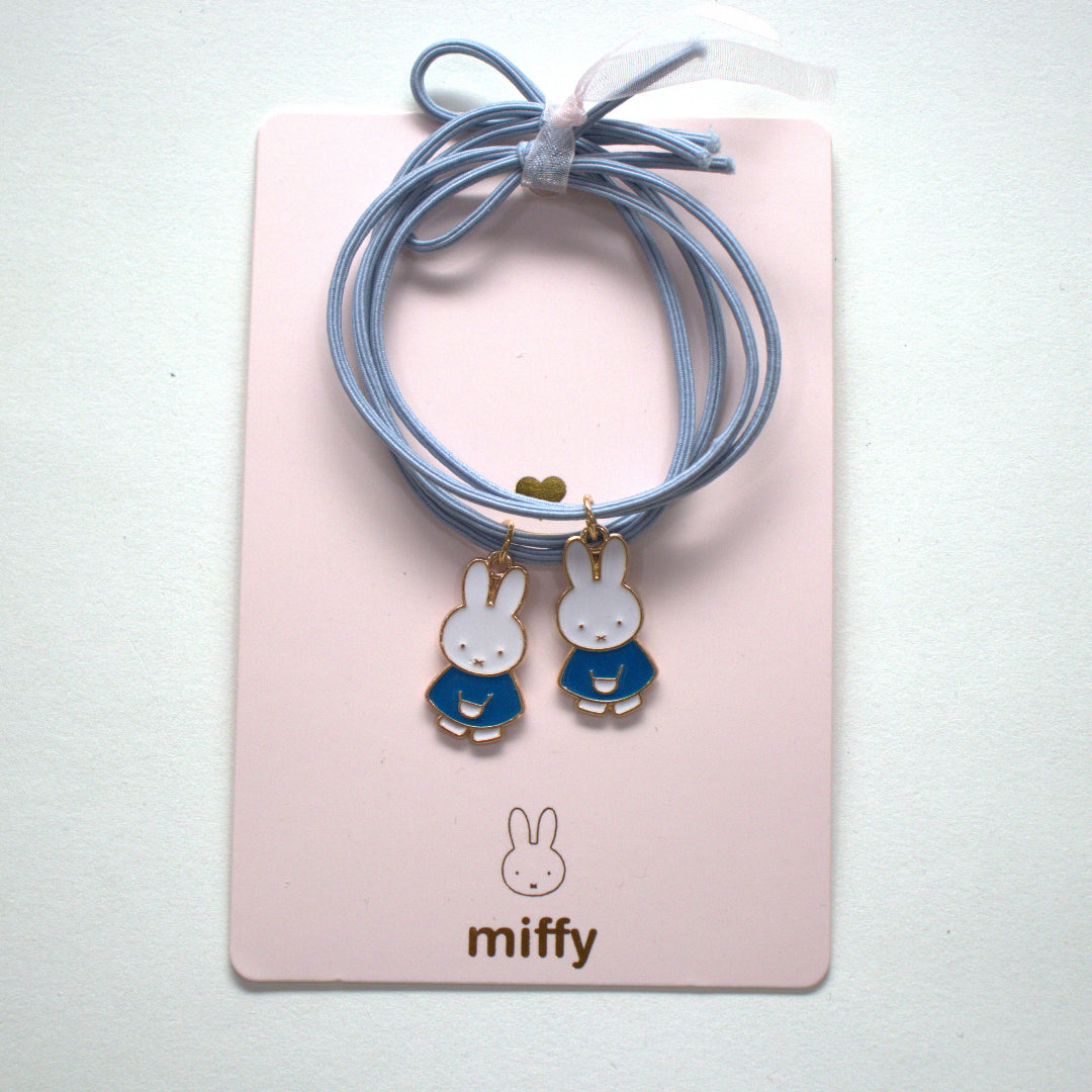 A pair of blue miffy hair elastics
