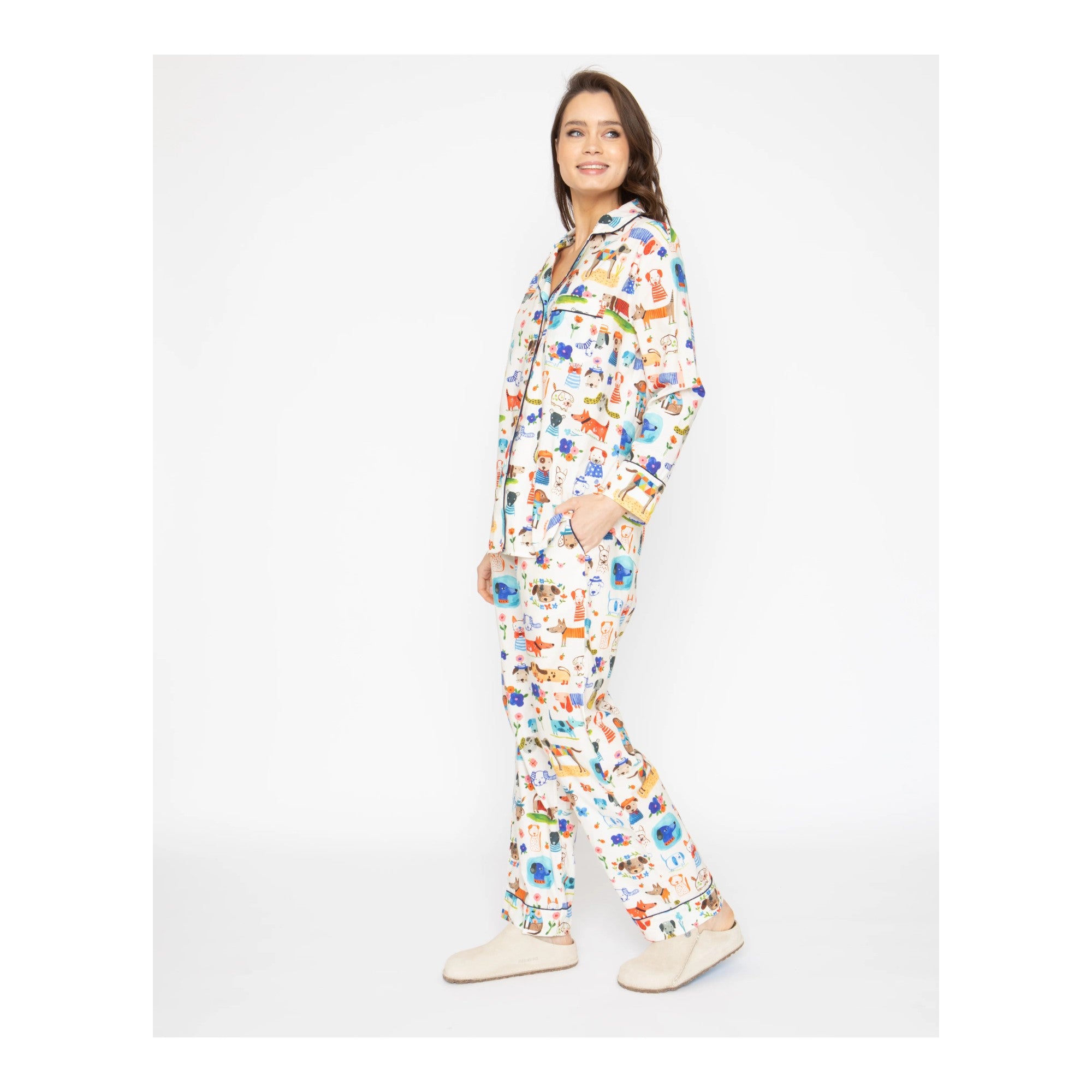 Woman wearing a colorful onesie with a pattern on a white background
