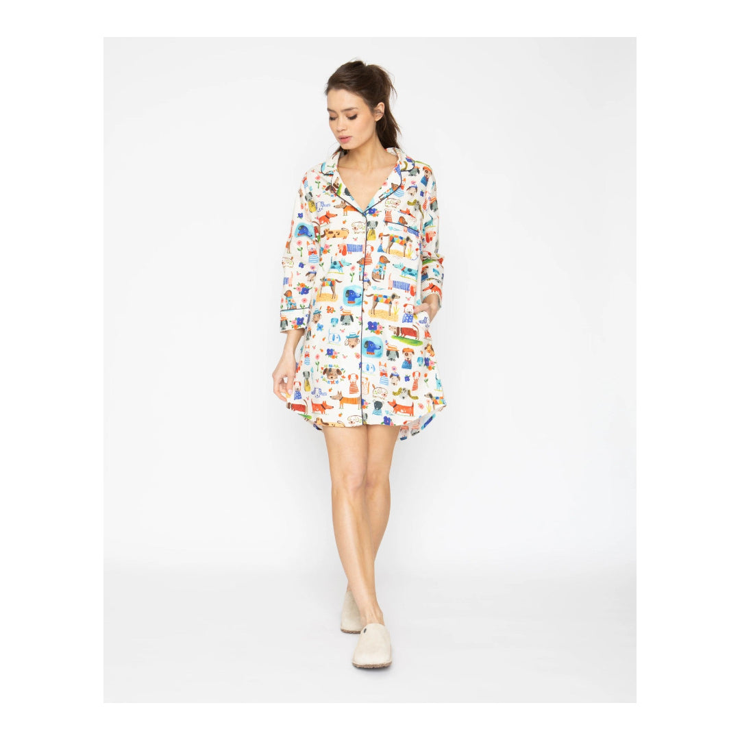 Woman wearing a colorful patterned shirt dress on a white background