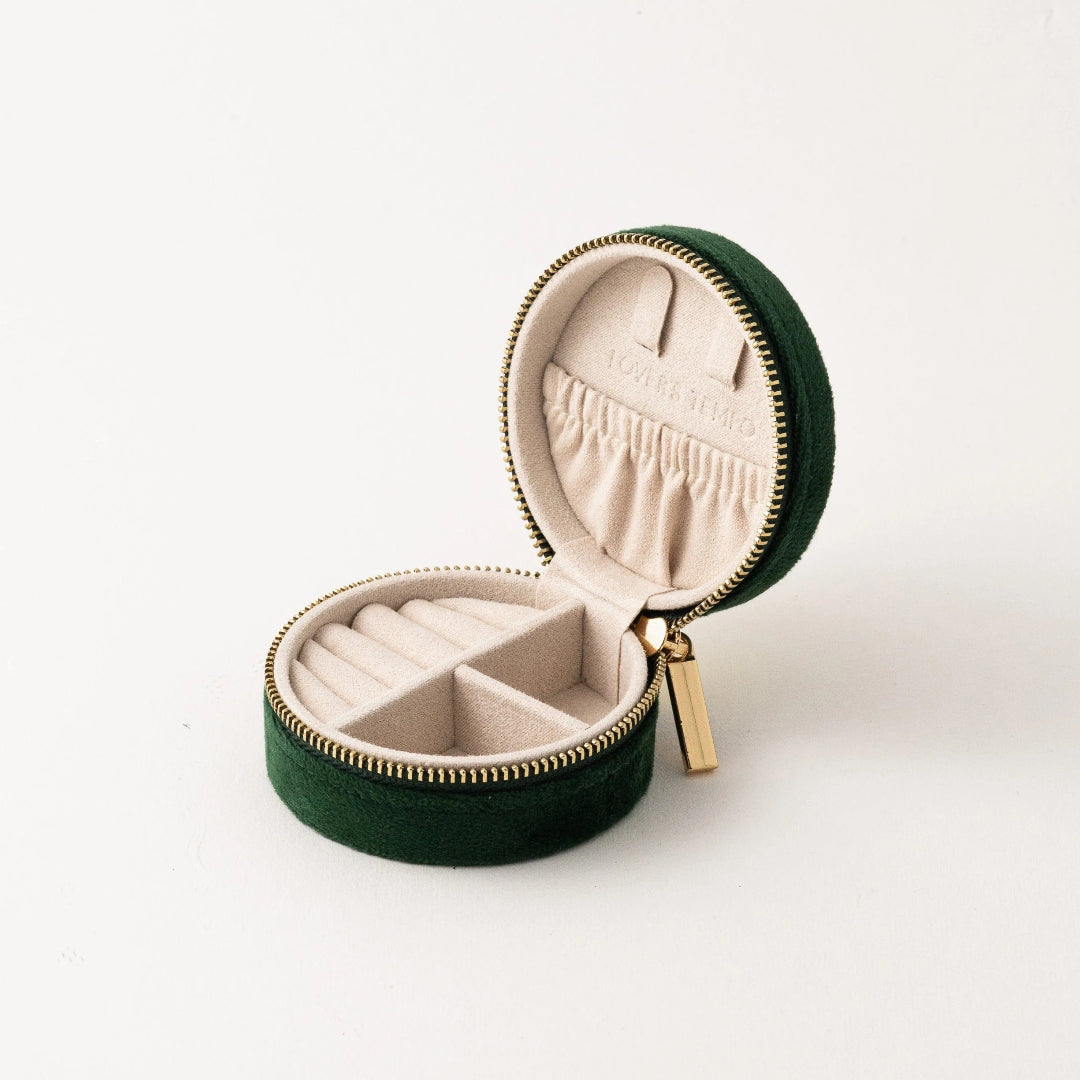 Green jewelry box with beige interior on a white background