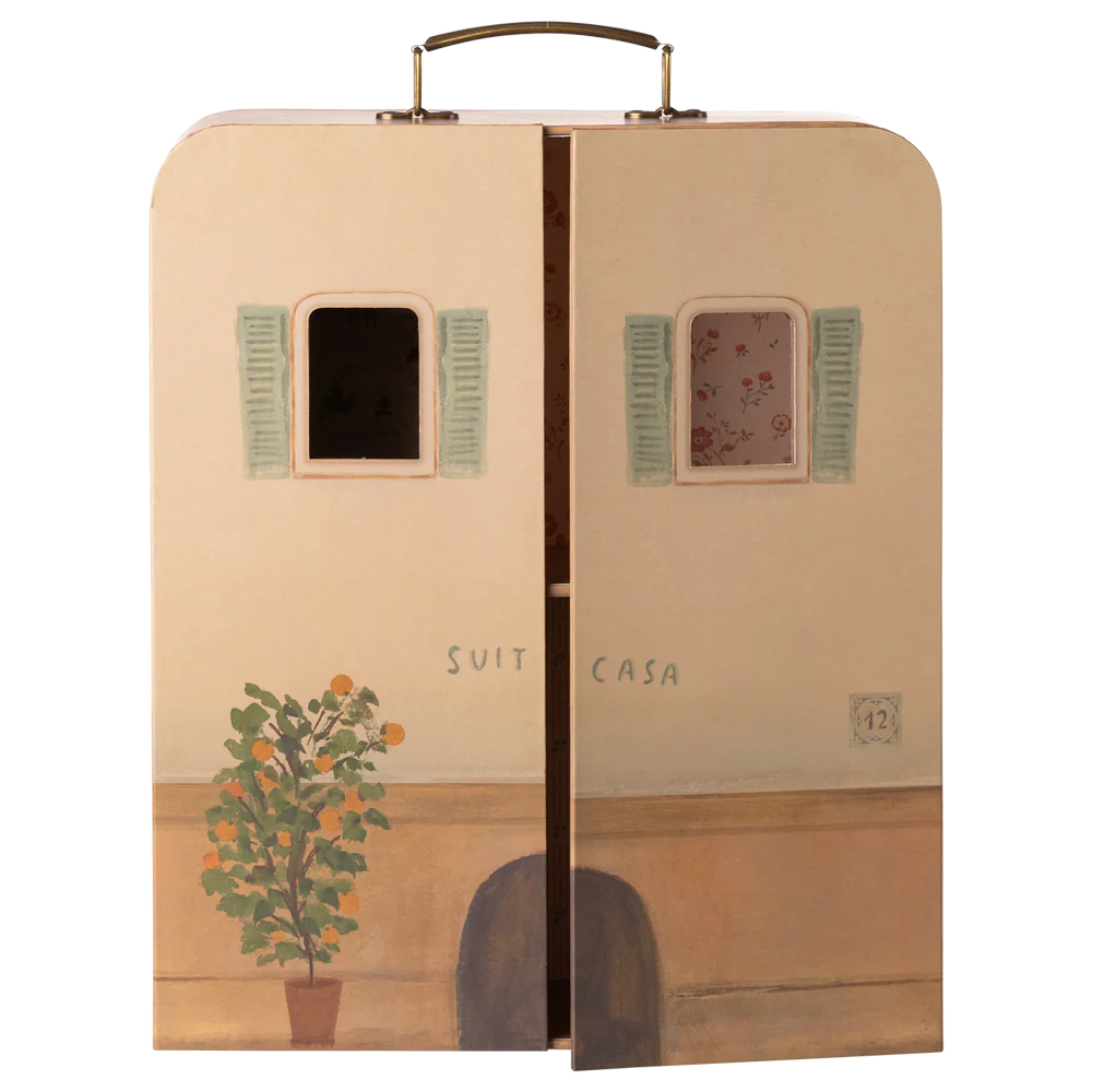 Suitcase with artistic design of a house, plant, and shutters on a white background