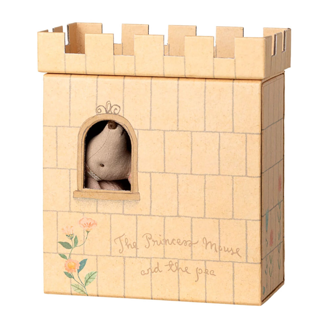 Cardboard castle toy with a small plush toy inside, on a white background