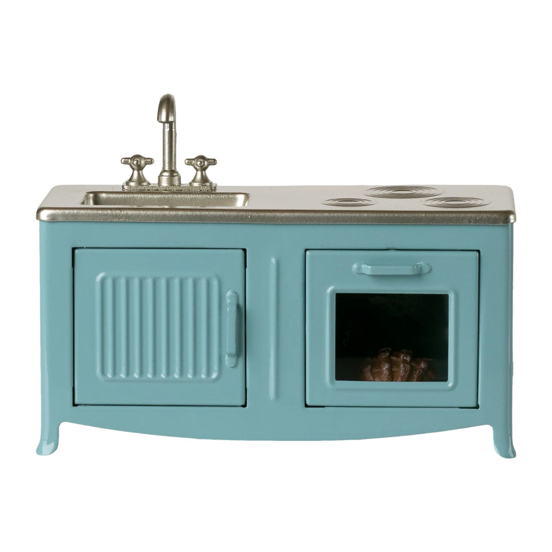 Teal stove with sink on a white background