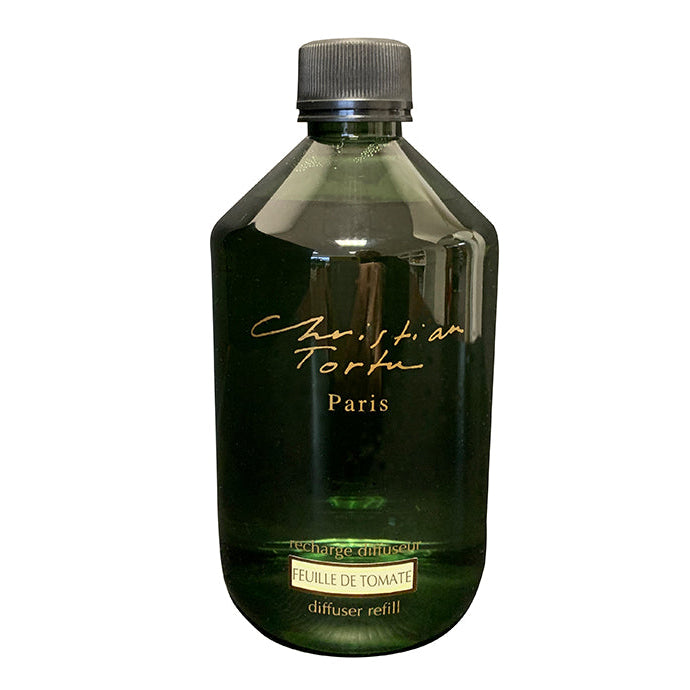 A bottle of Christian Tortu fragrance diffuser refill with a label indicating 'Paris - Tomato Leaf' and the brand name.