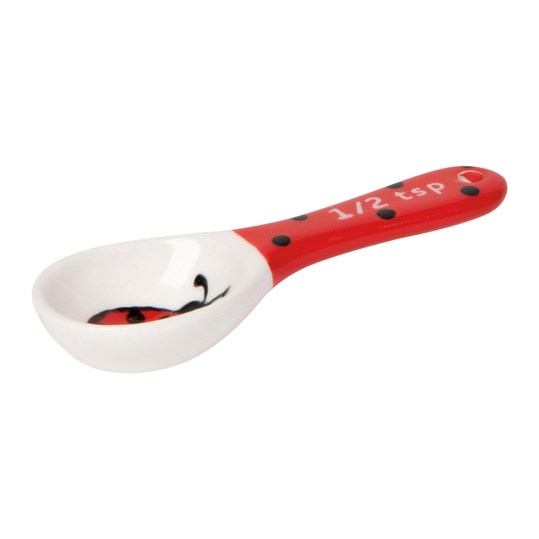 Measuring spoon with a ladybug design on a white background