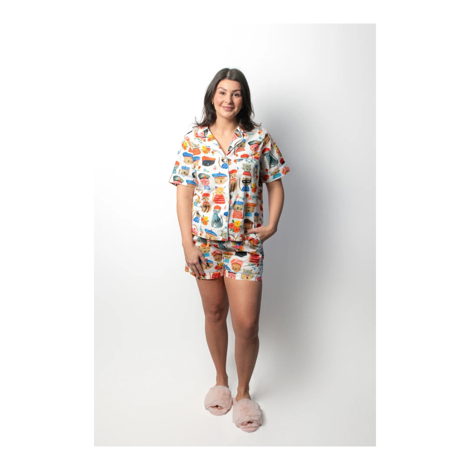 Woman wearing a colorful pajama set on a white background