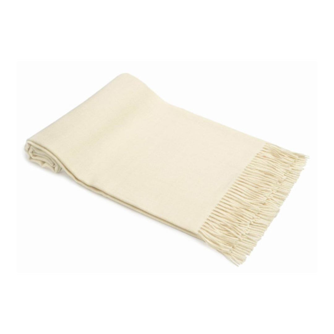 Beige blanket with fringed edge on a white background