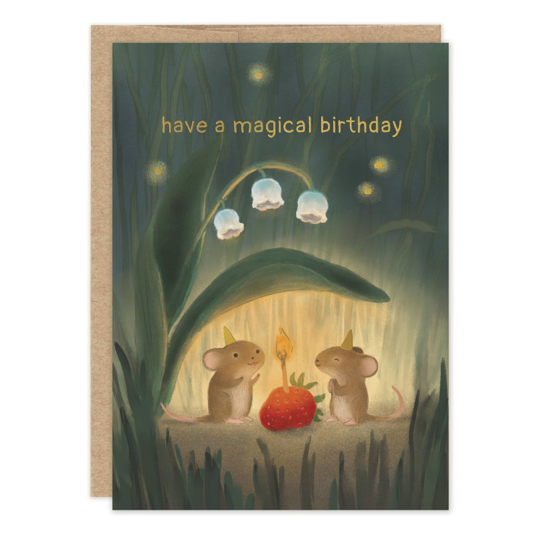 A greeting card with a kraft envelope, featuring an illustration of two tiny mice under a glowing leafy canopy beside a strawberry, with the text 'have a magical birthday' at the top.