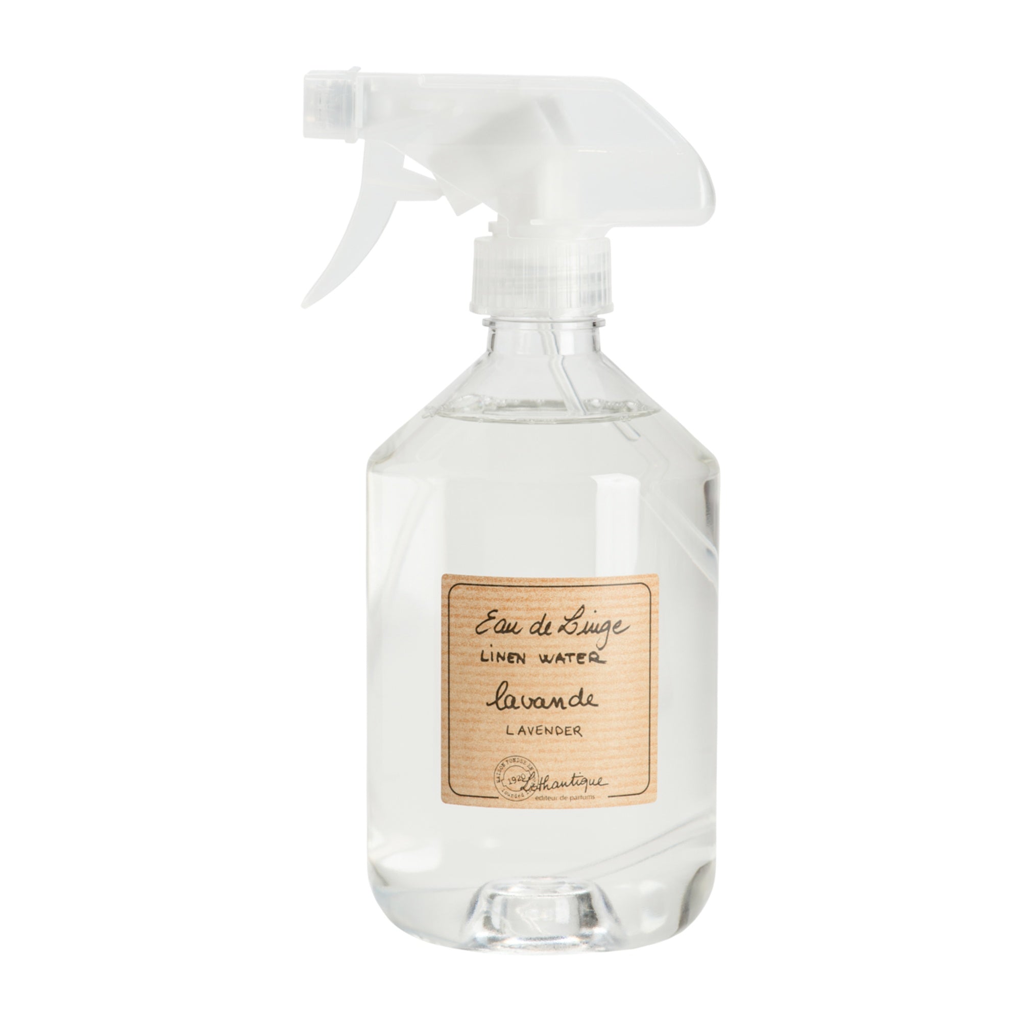 Clear spray bottle with a label on a white background