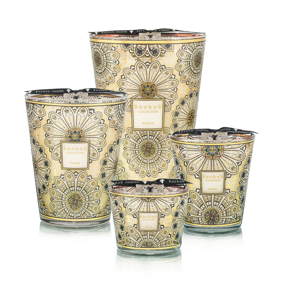 Set of four decorative candles with intricate patterns on a white background