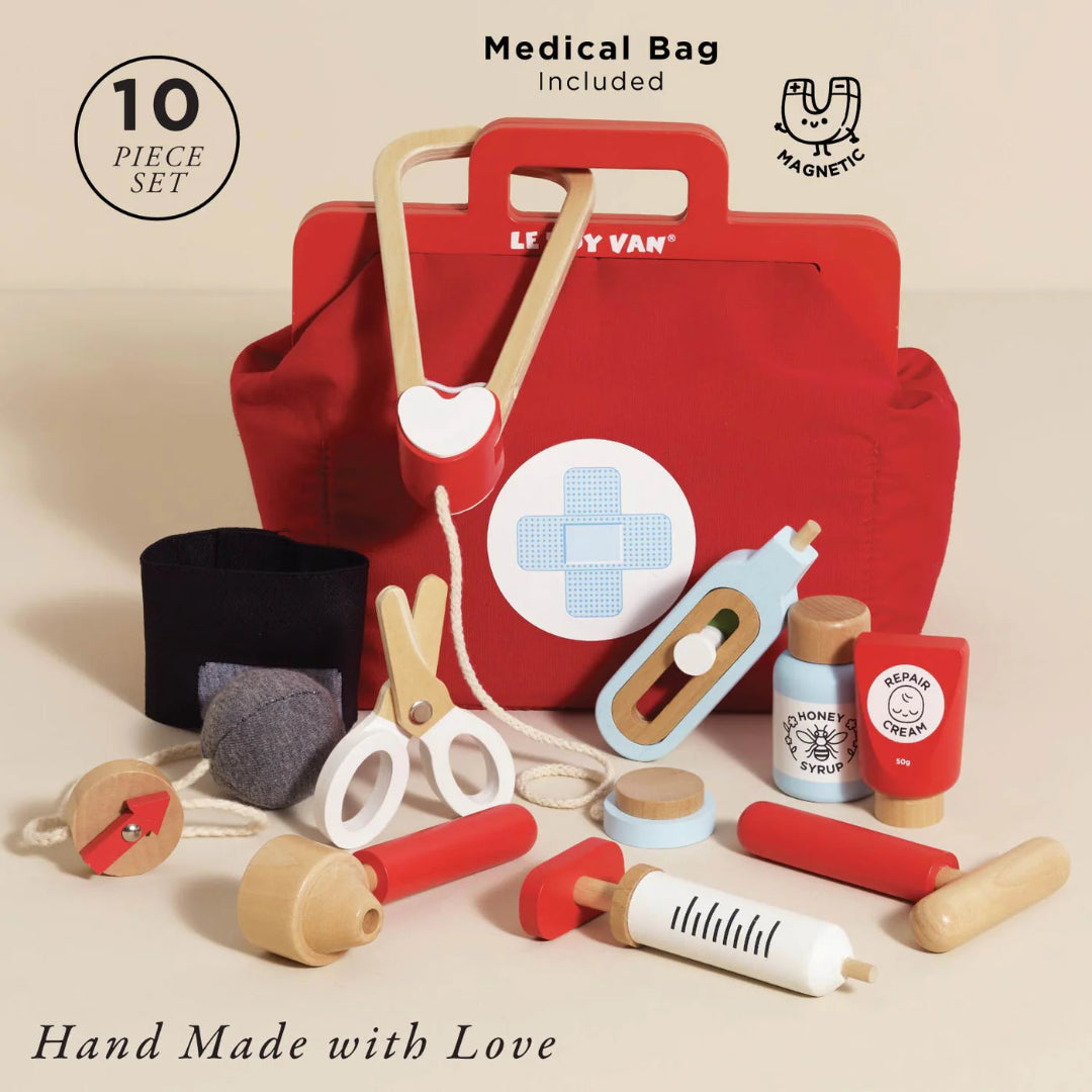 Toy medical set with red bag labeled 'Le Toy Van' on a beige background