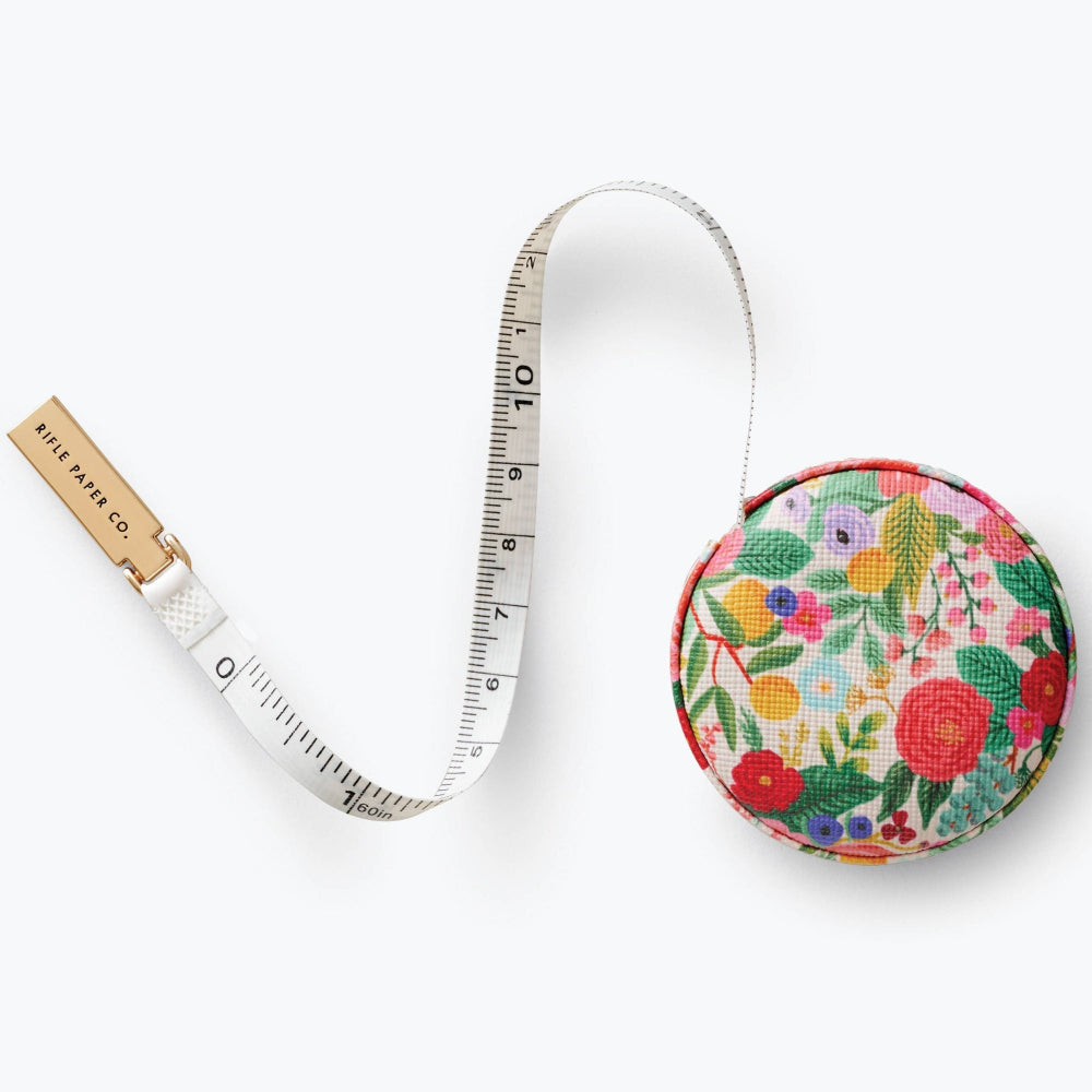 Tape measure with floral case on a white background