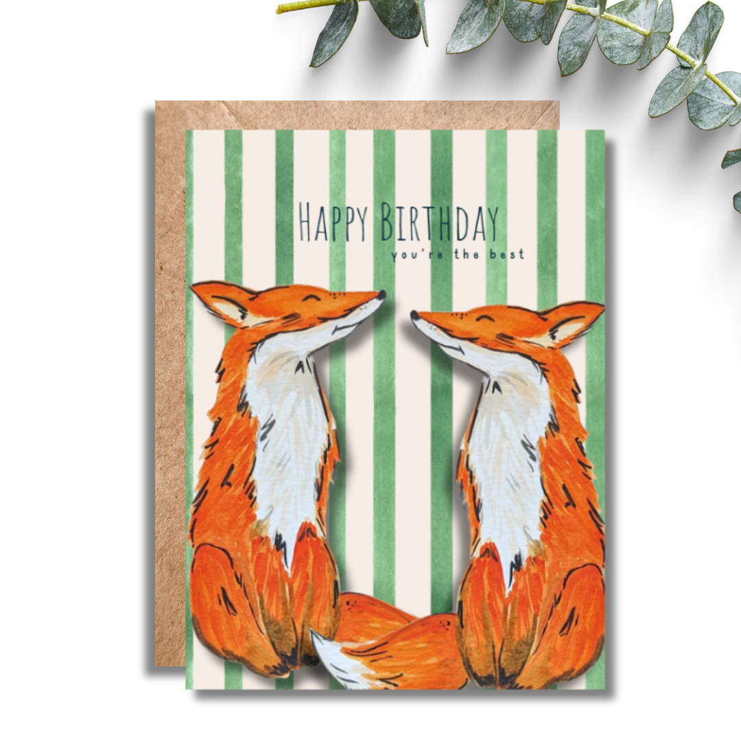 Birthday card with two foxes on a striped background