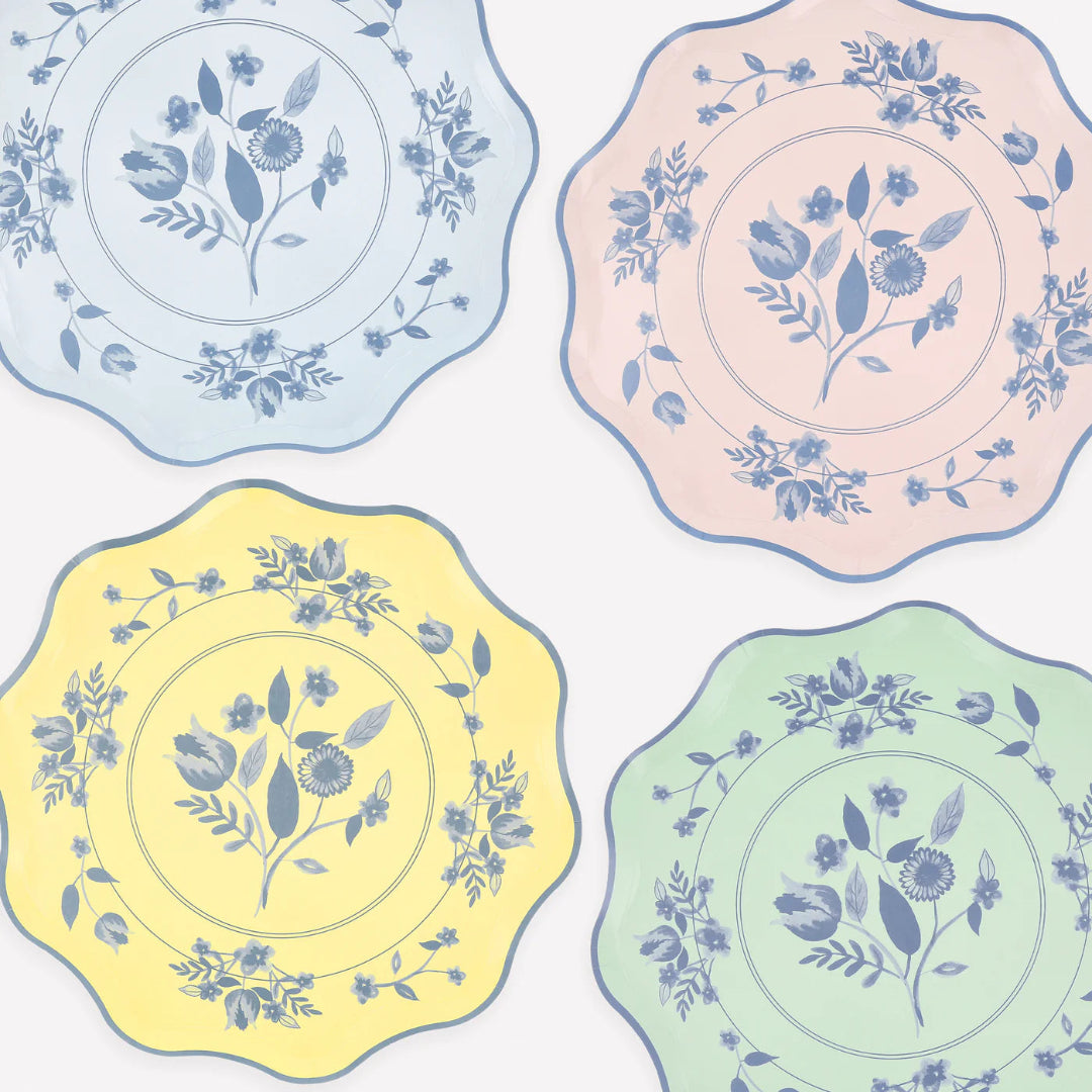 Four decorative plates with floral patterns in pastel colors on a light background