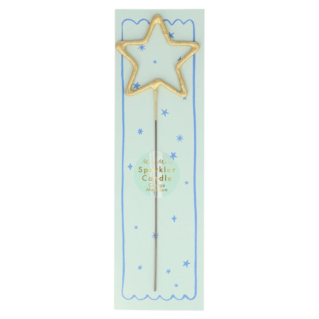 Gold star-shaped sparkler candle on a light green card with blue stars