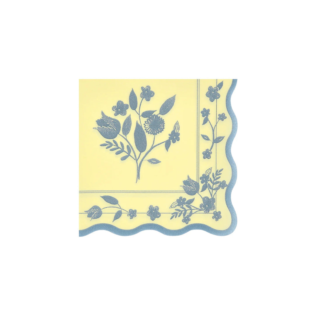 Yellow napkin with blue floral pattern on a white background