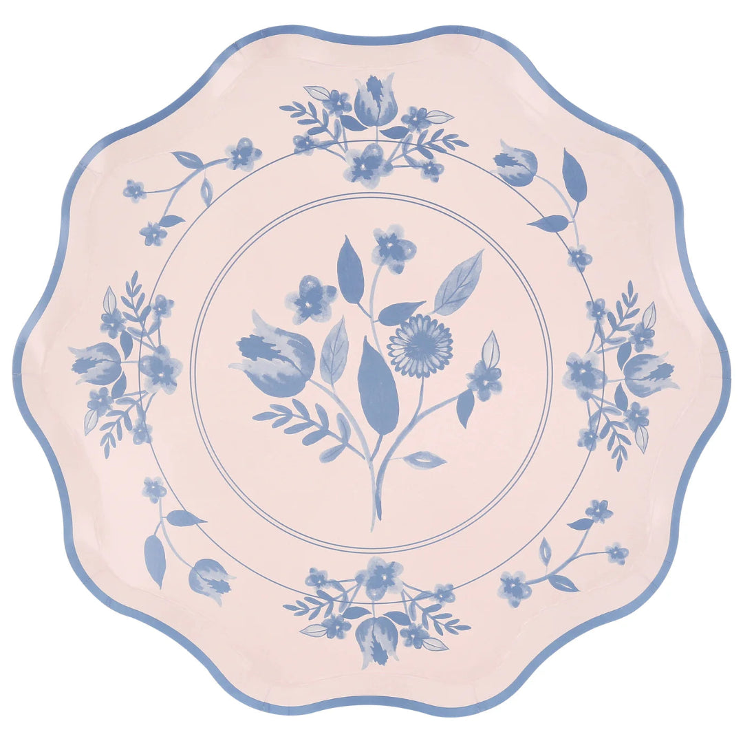 Decorative plate with blue floral design on a pink background