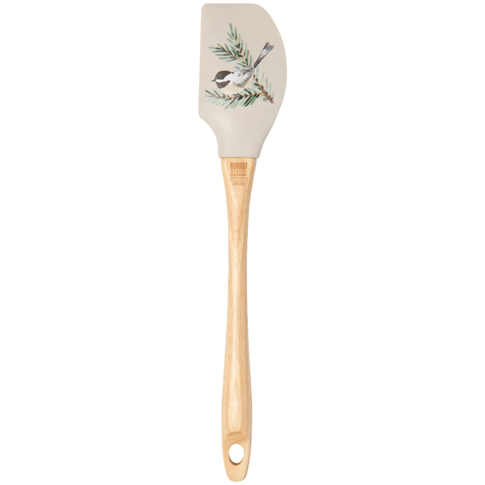 Silicone spatula with wooden handle and bird and branch design on beige background