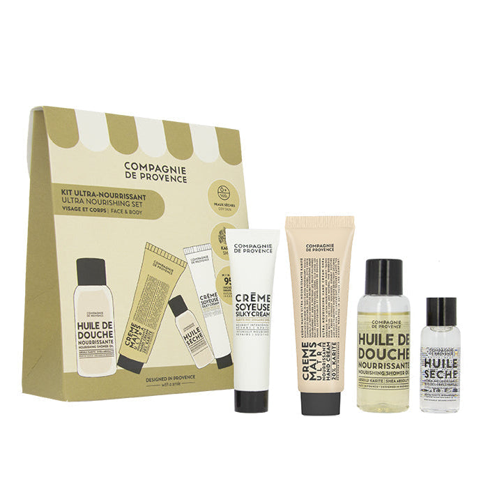 A gift box set containing four tubes of skin care products, labeled 'Compagnie de Provence Ultra Nourishing Shea Discovery Set'. The set includes a shower oil, hand cream, face cream, and a dry oil.