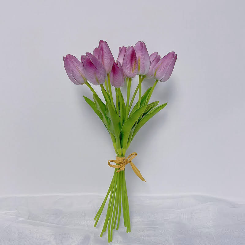 A bouquet of artificial purple tulips tied together, displayed against a white background.