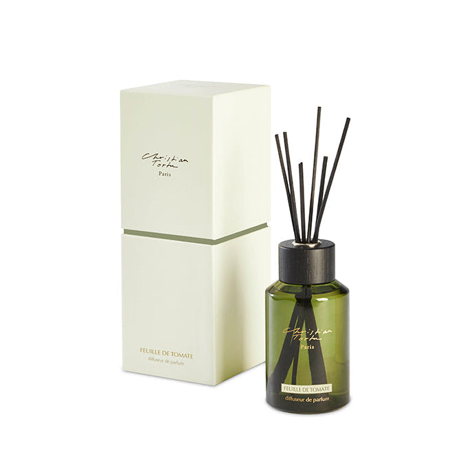 A Tomato Leaf fragrance diffuser bottle with reeds, alongside its white packaging box, both displaying the Christian Tortu brand.