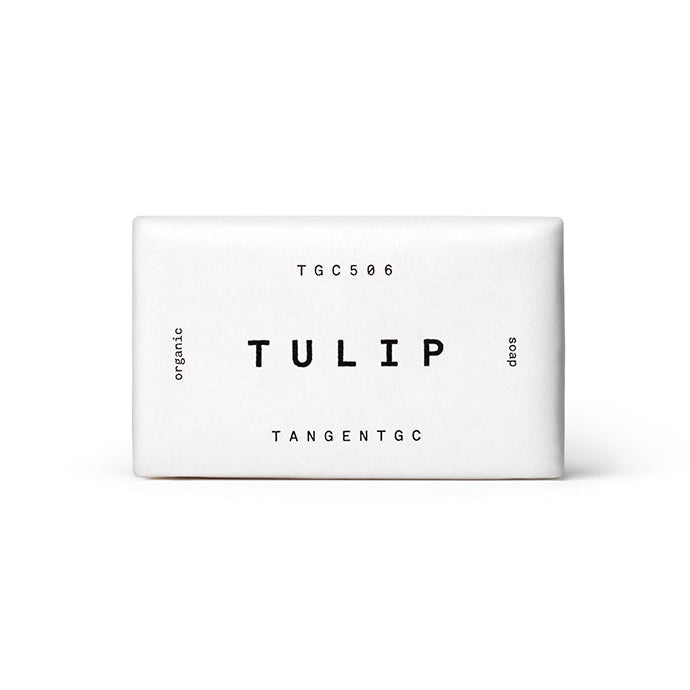 A white bar of soap with the word 'Tulip' and a tulip flower graphic on the packaging.