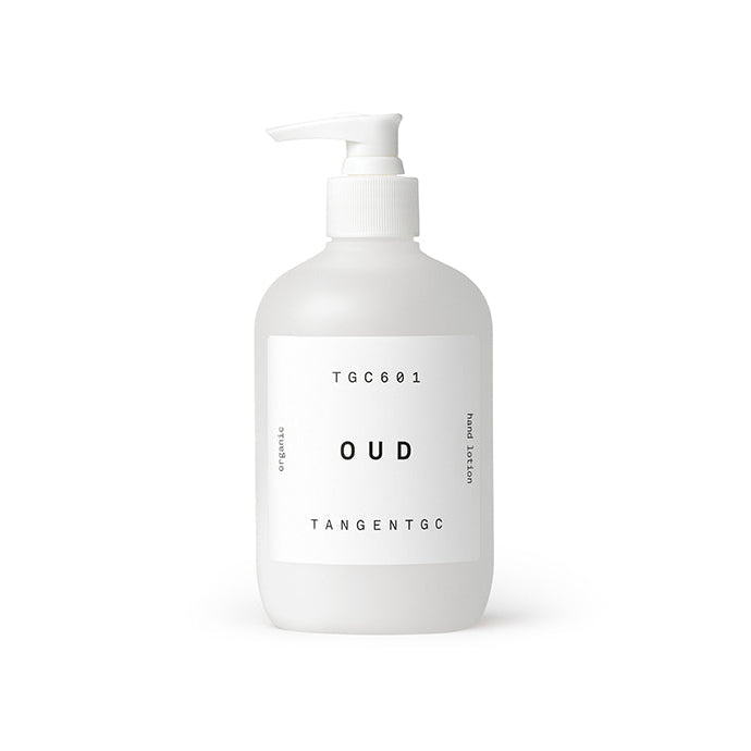 A white pump bottle labeled 'Tangent GC Oud' with a minimalistic design, indicating it is a hand lotion product.