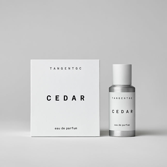 A silver bottle and white box with 'Tangent GC Cedar' branding, indicating it is an eau de parfum perfume.